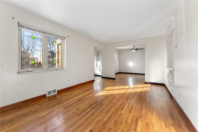 unfurnished room with hardwood / wood-style flooring and ceiling fan