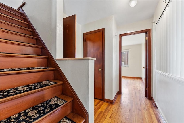 stairs featuring hardwood / wood-style floors