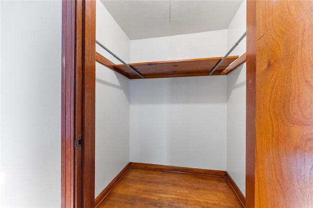 spacious closet with light hardwood / wood-style floors