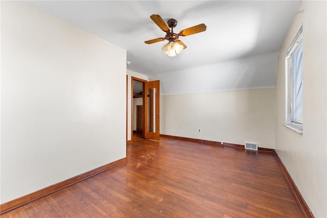 unfurnished room featuring lofted ceiling, dark hardwood / wood-style floors, and ceiling fan