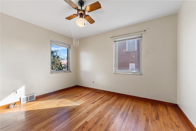 unfurnished room with light wood-type flooring and ceiling fan