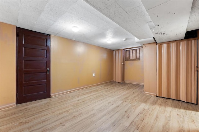 basement with light hardwood / wood-style floors