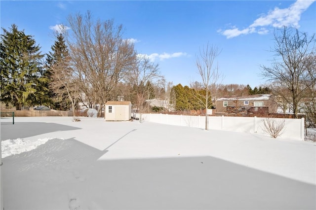 snowy yard with a shed