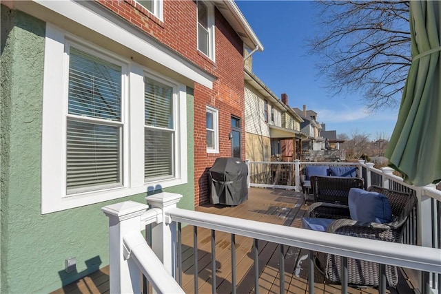 exterior space with a wooden deck and grilling area