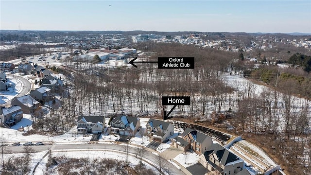 snowy aerial view featuring a residential view