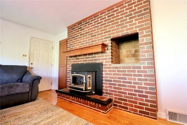 1219 Minnesota Ave, Natrona Hts/Harrison Twp, PA 15065 - living area featuring a wood stove, wood finished floors, and visible vents