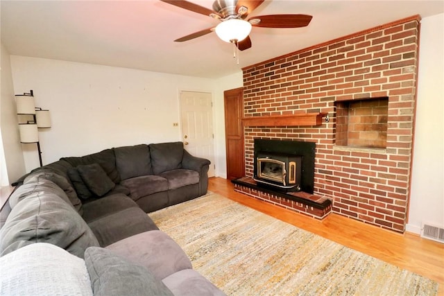 1219 Minnesota Ave, Natrona Hts/Harrison Twp, PA 15065 - living area featuring visible vents, a ceiling fan, wood finished floors, and a wood stove