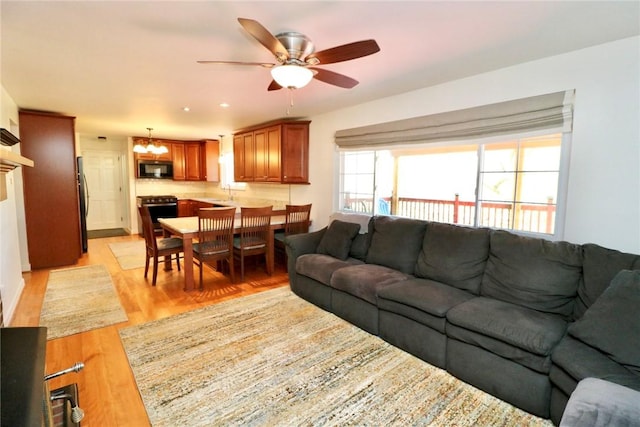 1219 Minnesota Ave, Natrona Hts/Harrison Twp, PA 15065 - living room with light wood-style floors and ceiling fan with notable chandelier