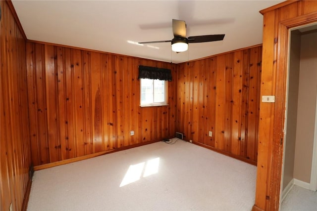 1219 Minnesota Ave, Natrona Hts/Harrison Twp, PA 15065 - carpeted spare room featuring baseboards, a ceiling fan, wood walls, and visible vents