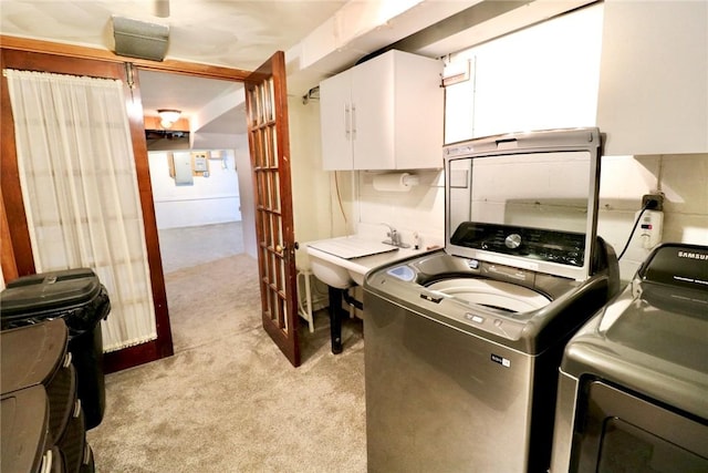 1219 Minnesota Ave, Natrona Hts/Harrison Twp, PA 15065 - laundry area with washing machine and clothes dryer, a sink, light colored carpet, and cabinet space