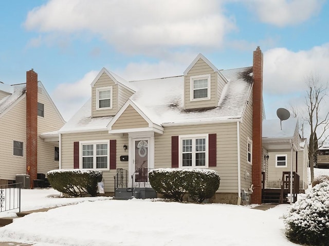 new england style home with central air condition unit