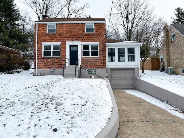 view of front facade featuring central AC and a garage