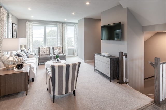 living area with light carpet, baseboards, and recessed lighting