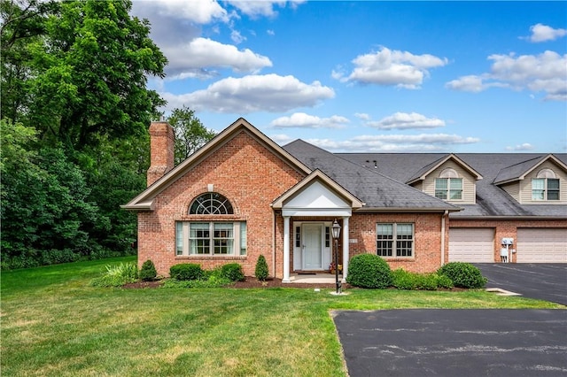 view of front of house featuring a garage and a front lawn