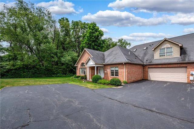 view of front of house featuring a front lawn and a garage