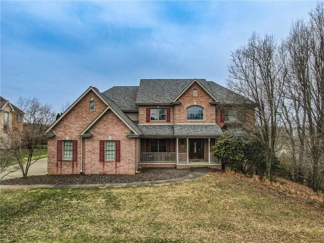 view of front of property featuring covered porch and a front yard