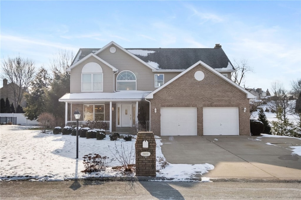 front of property featuring covered porch and a garage