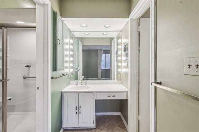 bathroom with a stall shower and vanity