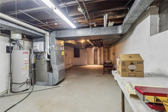 unfinished below grade area featuring gas water heater, electric panel, and heating unit