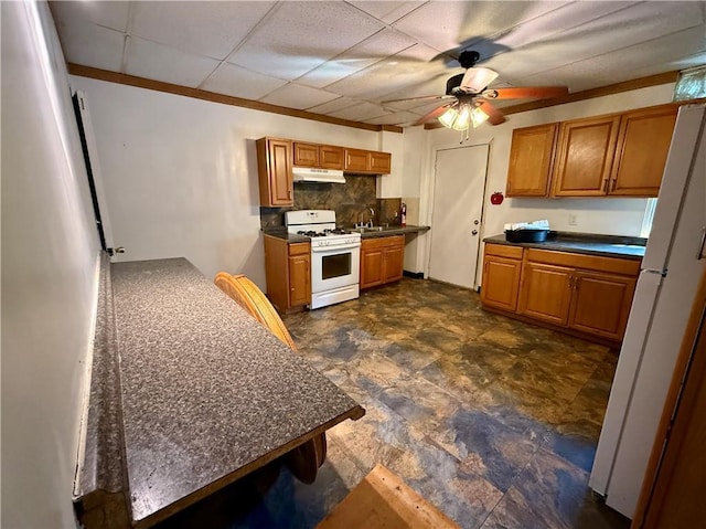1405-1407 W W, Homestead, PA 15120 - kitchen with white appliances, under cabinet range hood, a ceiling fan, brown cabinetry, and tasteful backsplash