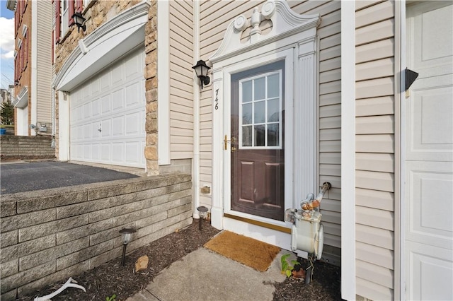 view of exterior entry with a garage