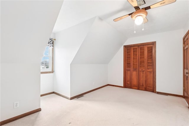 bonus room featuring ceiling fan, light colored carpet, and lofted ceiling