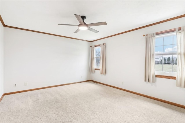 empty room with crown molding, carpet flooring, and ceiling fan