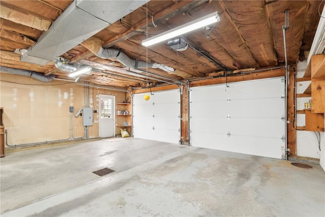 garage featuring electric panel and a garage door opener