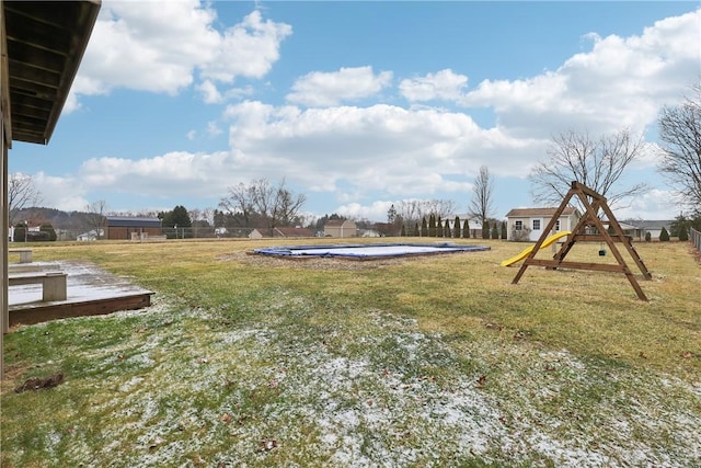 view of yard with a swimming pool and a playground