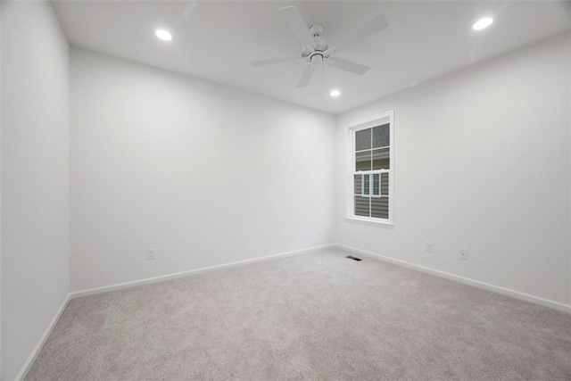 unfurnished room featuring ceiling fan, recessed lighting, carpet flooring, visible vents, and baseboards