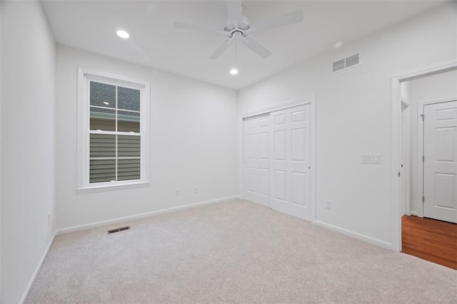 unfurnished bedroom featuring recessed lighting, visible vents, and light carpet