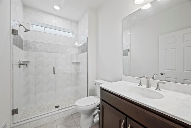 full bath with toilet, tile patterned floors, a stall shower, and vanity