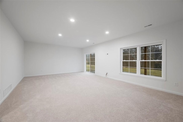 spare room featuring carpet, visible vents, baseboards, and recessed lighting