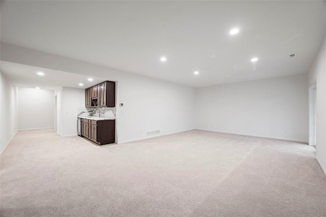 unfurnished living room featuring light colored carpet, recessed lighting, visible vents, and baseboards