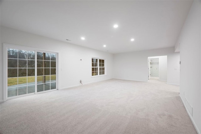 empty room with baseboards, light colored carpet, and recessed lighting