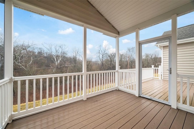 unfurnished sunroom featuring vaulted ceiling