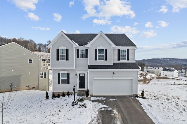 view of front property featuring a garage and a mountain view