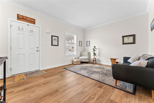 living area featuring ornamental molding, wood finished floors, and baseboards