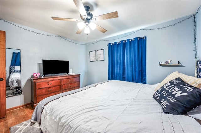 bedroom with hardwood / wood-style flooring and ceiling fan