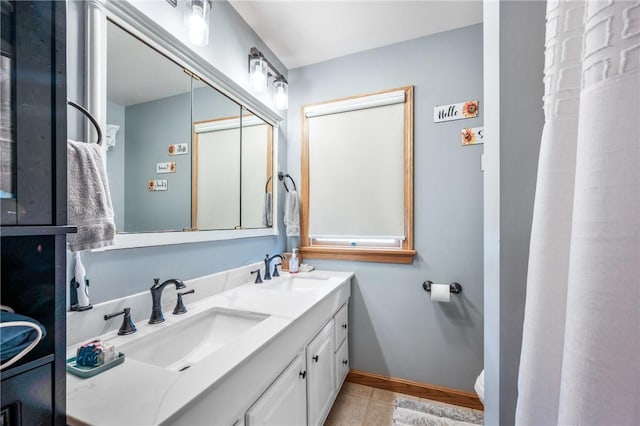 bathroom with toilet, tile patterned flooring, and vanity