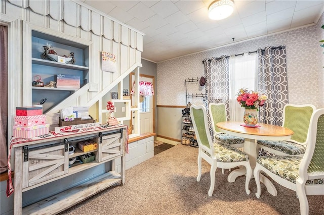 interior space featuring crown molding and carpet flooring