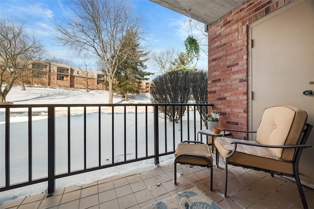 view of snow covered back of property