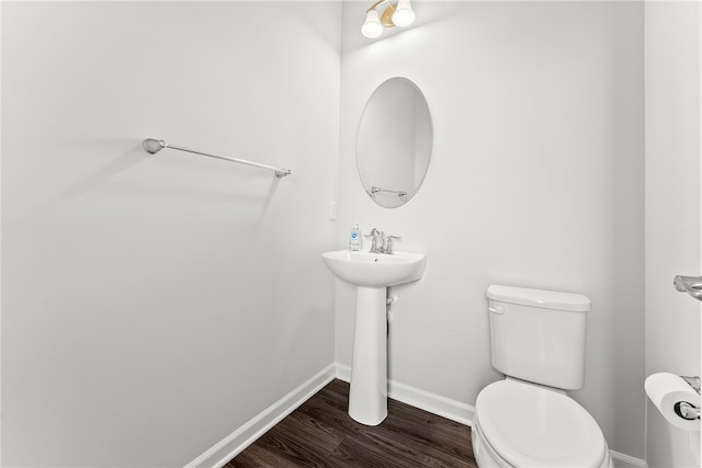 bathroom featuring hardwood / wood-style flooring and toilet