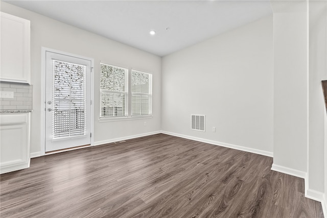 spare room with dark wood-type flooring