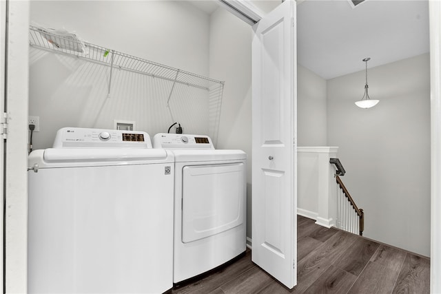 laundry room featuring dark hardwood / wood-style flooring and washer and clothes dryer