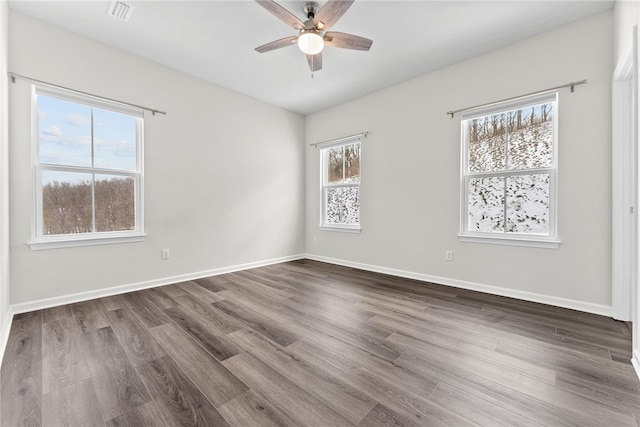 empty room featuring dark hardwood / wood-style floors and ceiling fan