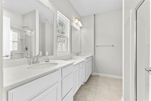 bathroom featuring a shower with shower door, vanity, and tile patterned flooring