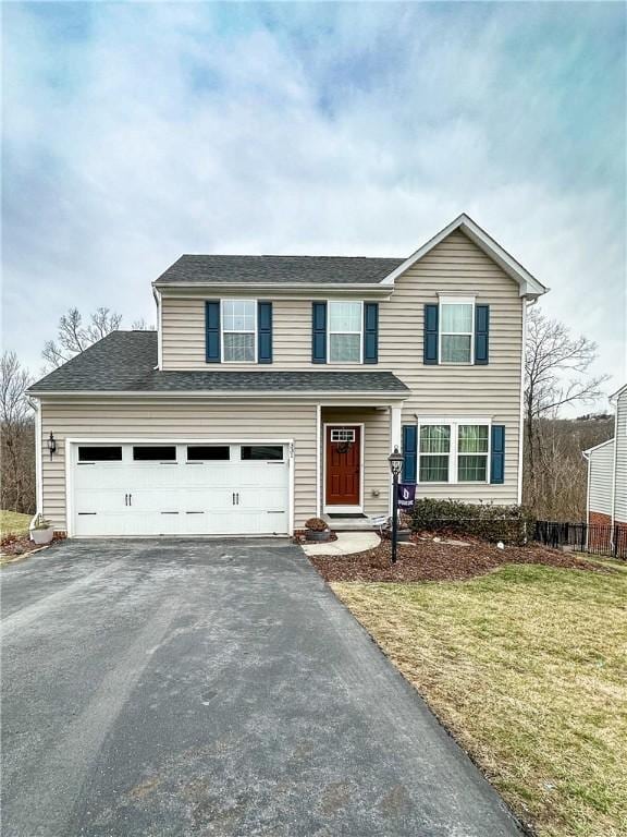 view of property with a front yard and a garage