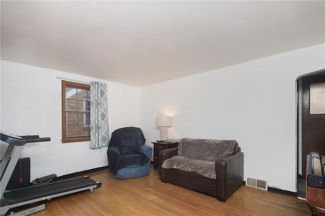 workout area with hardwood / wood-style floors