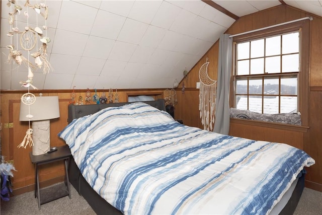 bedroom featuring lofted ceiling, carpet, and wooden walls